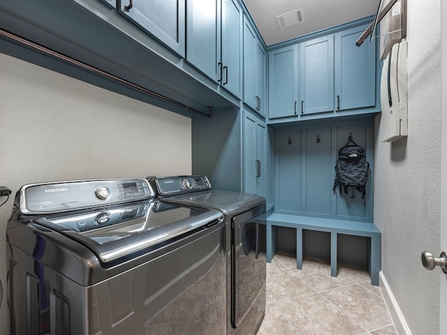 12118 Pinelands Park Ln, Humble, TX 77346 - laundry area featuring washer and clothes dryer, cabinet space, and light tile patterned floors
