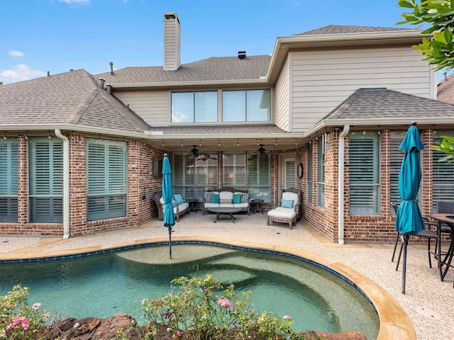 12118 Pinelands Park Ln, Humble, TX 77346 - back of property featuring brick siding, a ceiling fan, outdoor lounge area, and a chimney
