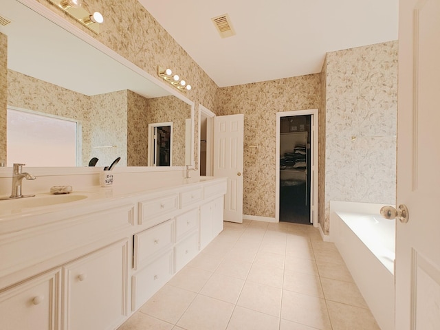 2631 Misty Grove Dr, Manvel, TX 77578 - bathroom with tile patterned floors, double vanity, a bath, and wallpapered walls