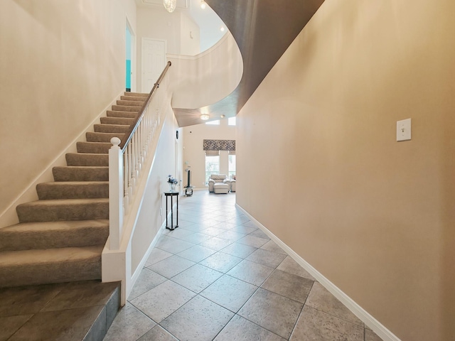 2631 Misty Grove Dr, Manvel, TX 77578 - stairs with a high ceiling, baseboards, and tile patterned flooring