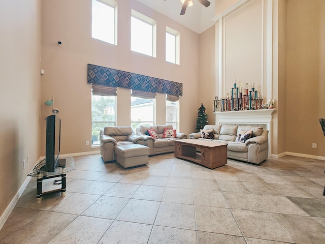 2631 Misty Grove Dr, Manvel, TX 77578 - living area featuring a ceiling fan, baseboards, healthy amount of natural light, and a high ceiling