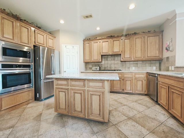 2631 Misty Grove Dr, Manvel, TX 77578 - kitchen featuring stainless steel appliances, tasteful backsplash, light stone counters, recessed lighting, and a kitchen island