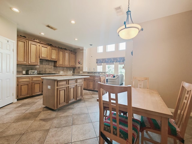 2631 Misty Grove Dr, Manvel, TX 77578 - kitchen with tasteful backsplash, a sink, recessed lighting, a center island, and brown cabinetry