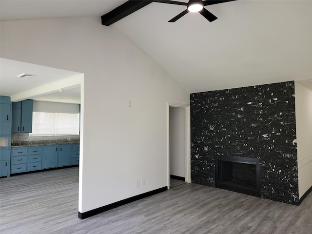 5814 Fontenelle Dr, Houston, TX 77035 - unfurnished living room featuring a ceiling fan, light wood-type flooring, a fireplace, and baseboards