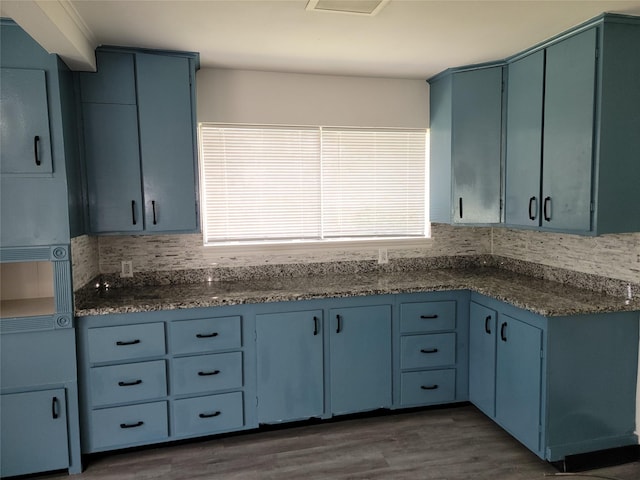 5814 Fontenelle Dr, Houston, TX 77035 - kitchen with blue cabinetry, wood finished floors, and decorative backsplash