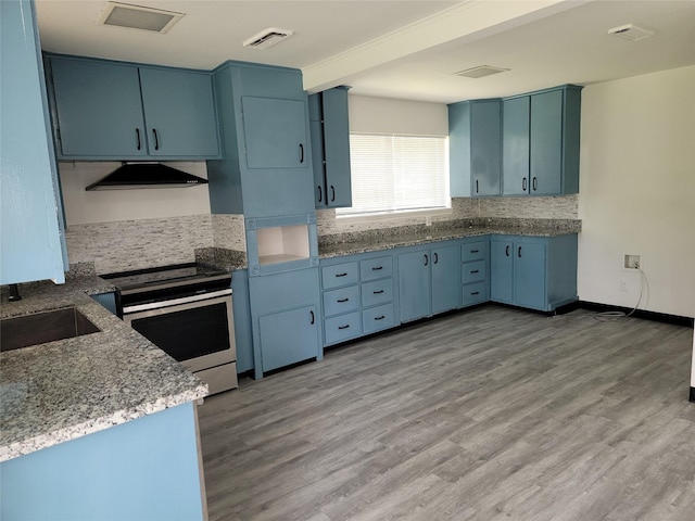 5814 Fontenelle Dr, Houston, TX 77035 - kitchen with stainless steel range with electric cooktop, under cabinet range hood, backsplash, a sink, and blue cabinetry