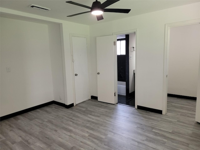 5814 Fontenelle Dr, Houston, TX 77035 - unfurnished bedroom featuring wood finished floors, ensuite bathroom, and a ceiling fan