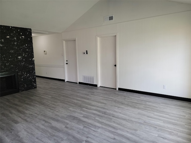 5814 Fontenelle Dr, Houston, TX 77035 - unfurnished living room featuring wood finished floors, high vaulted ceiling, and baseboards