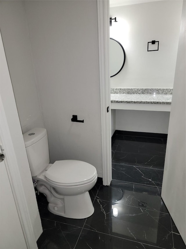 5814 Fontenelle Dr, Houston, TX 77035 - bathroom with marble finish flooring and toilet