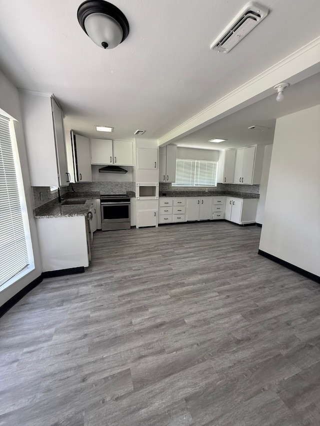 5814 Fontenelle Dr, Houston, TX 77035 - kitchen with stainless steel range with electric cooktop, dark countertops, white microwave, and white cabinets