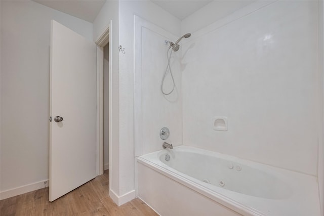 10918 Linden Gate Dr, Houston, TX 77075 - full bathroom with wood finished floors, a combined bath / shower with jetted tub, and baseboards
