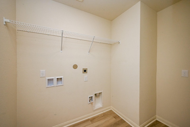 405 Elaine Valley Dr Unit D, Katy, TX 77493 - washroom featuring electric dryer hookup, light wood-type flooring, baseboards, and hookup for a washing machine