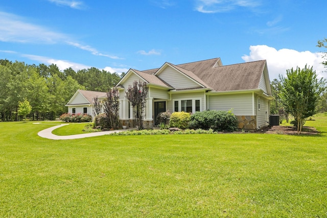 17772 W Terrace Oaks, Waller, TX 77484 - view of front of property with central AC, a front yard, and a shingled roof