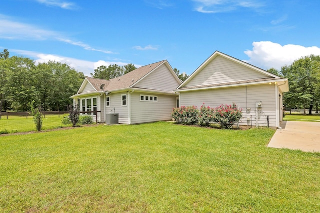 17772 W Terrace Oaks, Waller, TX 77484 - rear view of property with central AC unit and a yard