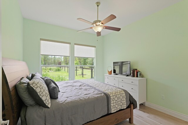 17772 W Terrace Oaks, Waller, TX 77484 - bedroom with light wood-style floors, baseboards, and a ceiling fan