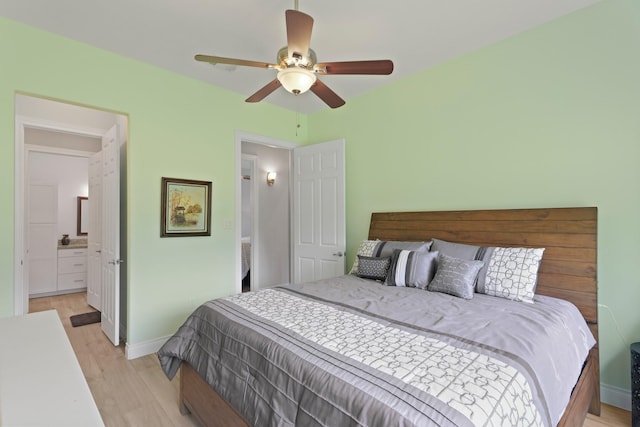 17772 W Terrace Oaks, Waller, TX 77484 - bedroom featuring light wood-style floors, baseboards, a ceiling fan, and ensuite bath