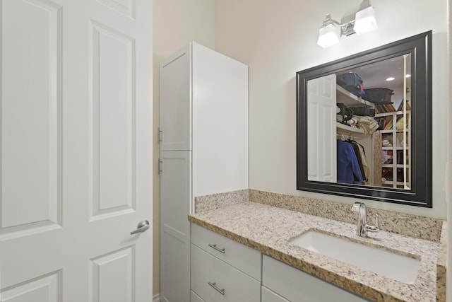 17772 W Terrace Oaks, Waller, TX 77484 - bathroom with vanity and a walk in closet
