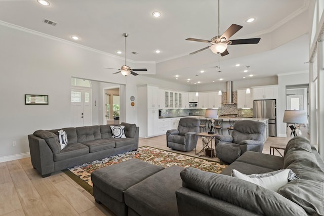 17772 W Terrace Oaks, Waller, TX 77484 - living room featuring a ceiling fan, crown molding, light wood finished floors, recessed lighting, and baseboards