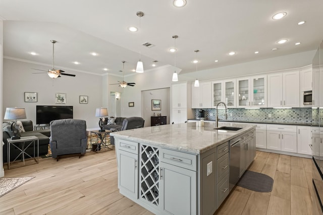 17772 W Terrace Oaks, Waller, TX 77484 - kitchen featuring a sink, a ceiling fan, stainless steel appliances, white cabinets, and crown molding