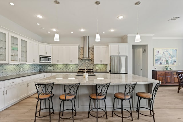 17772 W Terrace Oaks, Waller, TX 77484 - kitchen with wall chimney exhaust hood, stainless steel appliances, crown molding, white cabinets, and recessed lighting