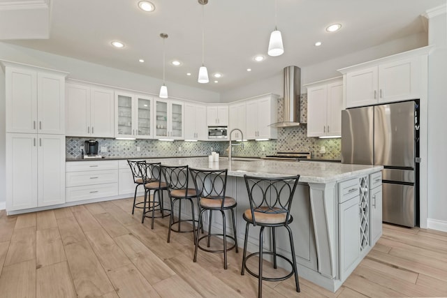 17772 W Terrace Oaks, Waller, TX 77484 - kitchen featuring wall chimney range hood, appliances with stainless steel finishes, a sink, white cabinetry, and recessed lighting