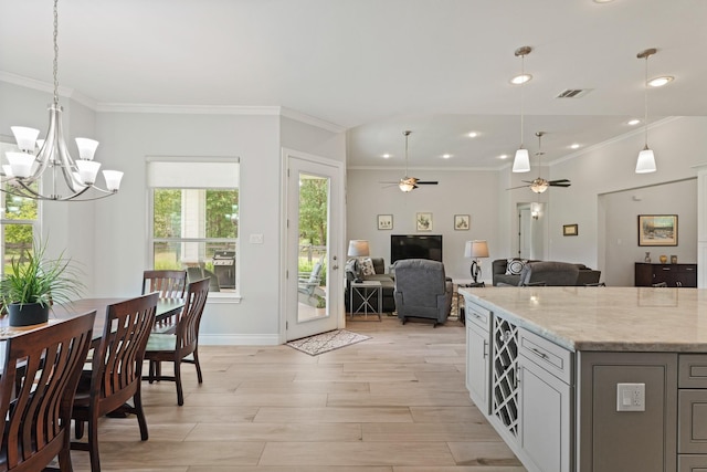 17772 W Terrace Oaks, Waller, TX 77484 - dining area featuring crown molding, a chandelier, a ceiling fan, light wood-style flooring, and baseboards