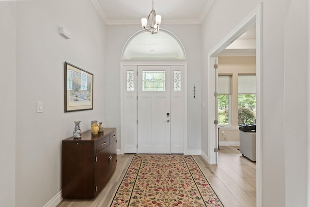 17772 W Terrace Oaks, Waller, TX 77484 - foyer featuring light wood-style floors, crown molding, a chandelier, and baseboards