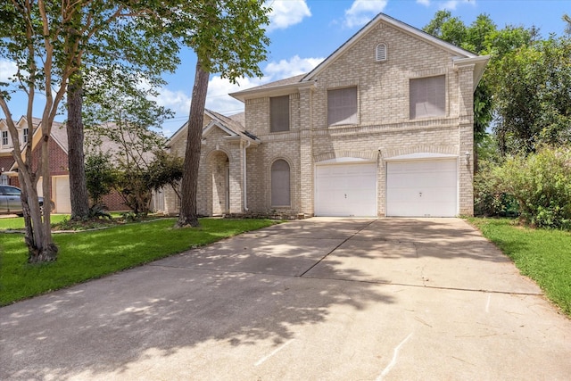 21326 Wildcroft Dr, Katy, TX 77449 - view of front of home with brick siding, an attached garage, driveway, and a front yard