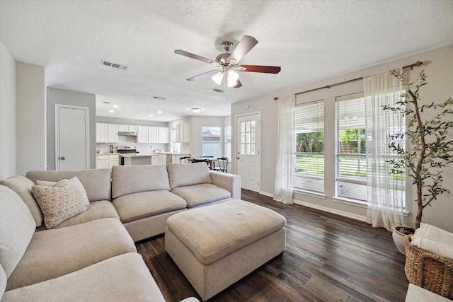 21326 Wildcroft Dr, Katy, TX 77449 - living area featuring a ceiling fan, dark wood-style flooring, a textured ceiling, baseboards, and recessed lighting