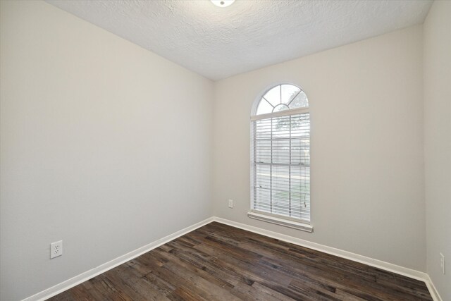21326 Wildcroft Dr, Katy, TX 77449 - unfurnished room featuring baseboards, dark wood-style flooring, and a textured ceiling