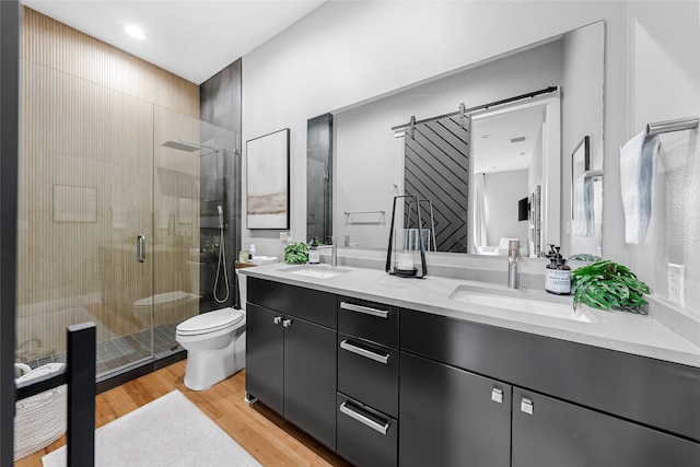 20107 Continental Dr Unit A, Lago Vista, TX 78645 - bathroom featuring double vanity, a stall shower, and wood finished floors