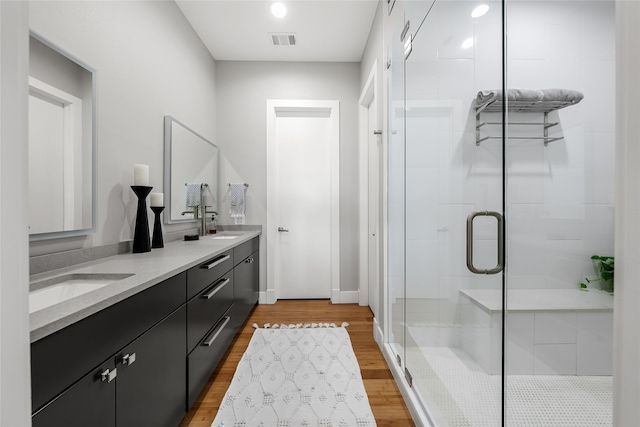 20107 Continental Dr Unit A, Lago Vista, TX 78645 - full bath with double vanity, a shower stall, and wood finished floors