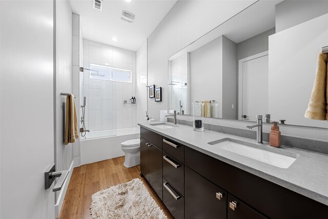 20107 Continental Dr Unit A, Lago Vista, TX 78645 - bathroom with double vanity, wood finished floors, and shower / bathtub combination