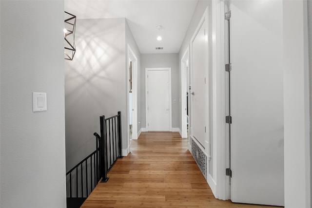 20107 Continental Dr Unit A, Lago Vista, TX 78645 - hall with an upstairs landing, light wood finished floors, and a chandelier