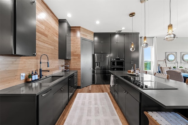 20107 Continental Dr Unit A, Lago Vista, TX 78645 - kitchen with tasteful backsplash, black appliances, decorative light fixtures, dark countertops, and light wood-type flooring