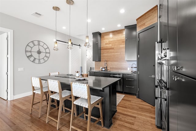 20107 Continental Dr Unit A, Lago Vista, TX 78645 - kitchen featuring decorative backsplash, a center island, recessed lighting, a kitchen bar, and light wood-type flooring