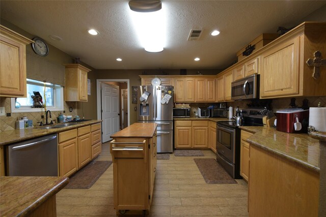 7523 State Highway 21 W, Caldwell, TX 77836 - kitchen featuring stainless steel appliances, a sink, decorative backsplash, a textured ceiling, and recessed lighting