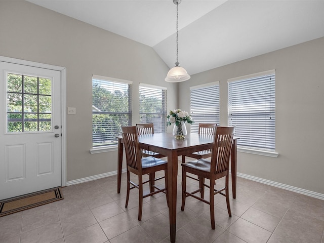 14402 Cottage Timbers Ln, Houston, TX 77044 - dining room featuring lofted ceiling, baseboards, and light tile patterned floors