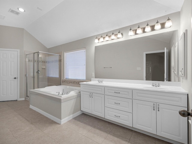 14402 Cottage Timbers Ln, Houston, TX 77044 - bathroom featuring a stall shower, a bath, double vanity, tile patterned flooring, and lofted ceiling