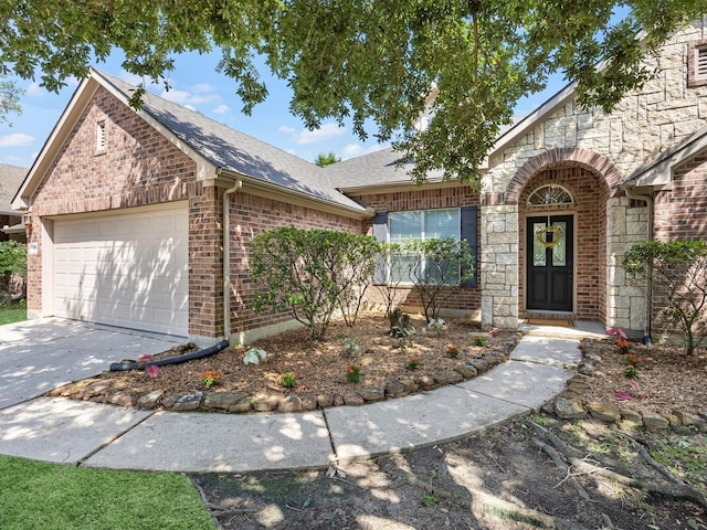 14402 Cottage Timbers Ln, Houston, TX 77044 - view of front of house featuring brick siding, an attached garage, stone siding, and a shingled roof