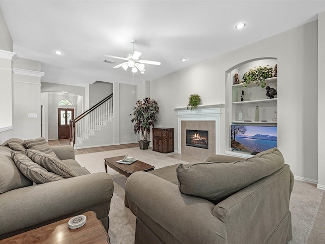 14402 Cottage Timbers Ln, Houston, TX 77044 - living room with ceiling fan, a tile fireplace, arched walkways, stairs, and recessed lighting