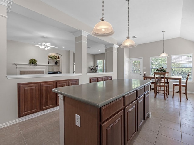 14402 Cottage Timbers Ln, Houston, TX 77044 - kitchen featuring ornate columns, a center island, light tile patterned flooring, healthy amount of natural light, and lofted ceiling