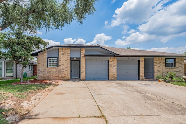 5130 Beaverhollow Dr, Houston, TX 77084 - view of front of home with an attached garage, brick siding, and driveway