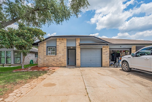 5130 Beaverhollow Dr, Houston, TX 77084 - view of front of home featuring brick siding, an attached garage, and driveway