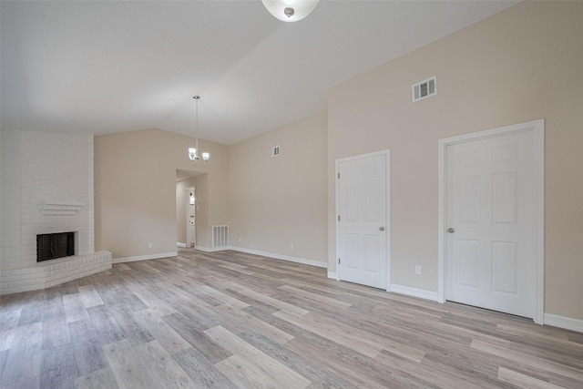 5130 Beaverhollow Dr, Houston, TX 77084 - unfurnished living room featuring light wood-type flooring, a brick fireplace, baseboards, a chandelier, and high vaulted ceiling