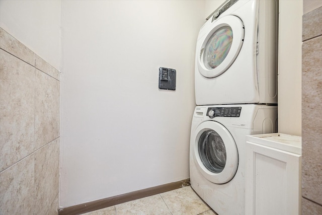 1849 Marshall St Unit 1, Houston, TX 77098 - laundry area featuring estacked washer and dryer and light tile patterned flooring