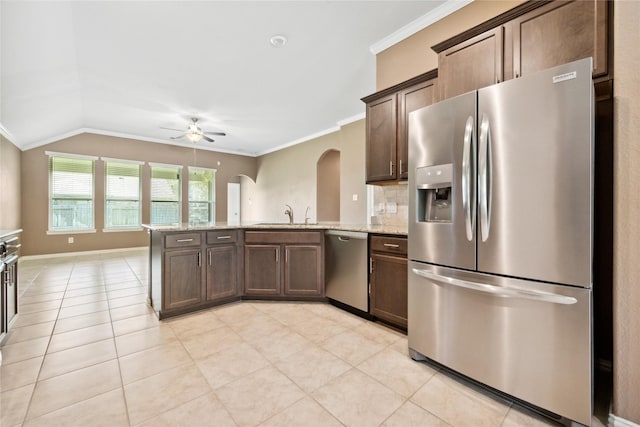 18934 Sorrento Point Dr, New Caney, TX 77357 - kitchen featuring appliances with stainless steel finishes, ceiling fan, a peninsula, ornamental molding, and arched walkways