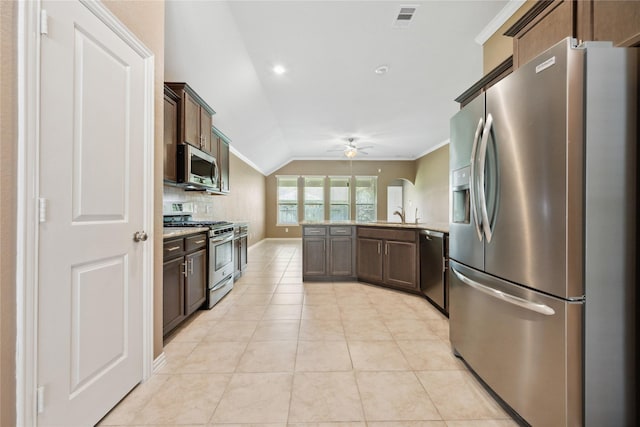 18934 Sorrento Point Dr, New Caney, TX 77357 - kitchen with stainless steel appliances, ceiling fan, a peninsula, ornamental molding, and lofted ceiling