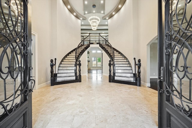 10306 Grape Creek Grove Ln, Cypress, TX 77433 - foyer entrance with arched walkways, stairs, a chandelier, a towering ceiling, and baseboards
