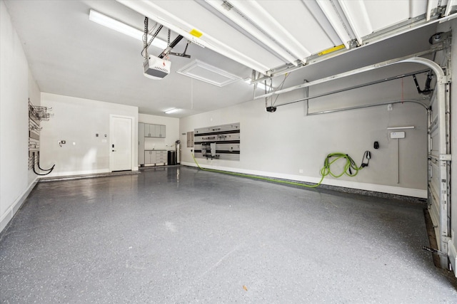 10306 Grape Creek Grove Ln, Cypress, TX 77433 - garage featuring baseboards and a garage door opener